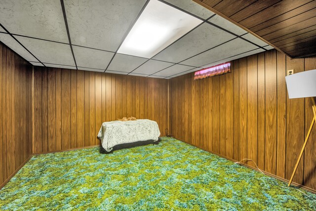 32334 Gloede Dr, Warren, MI 48088 - unfurnished bedroom featuring wood walls, a drop ceiling, and carpet floors