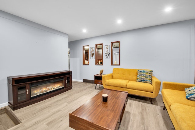 32334 Gloede Dr, Warren, MI 48088 - living area with a glass covered fireplace, recessed lighting, light wood-style flooring, and baseboards