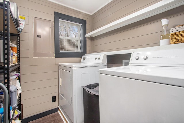 12934 Wilson Rd, Fruitport, MI 49415 - laundry area featuring washer and dryer, electric panel, laundry area, dark wood-type flooring, and wood walls