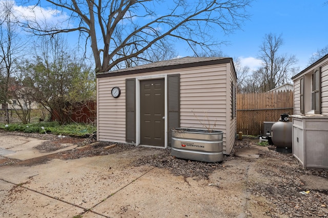 view of shed featuring fence