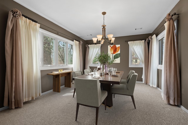 dining area featuring light carpet, visible vents, baseboards, and an inviting chandelier