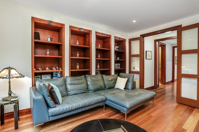 living area featuring light wood finished floors and baseboards