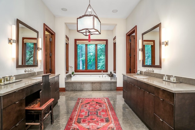 bathroom featuring two vanities and a bath