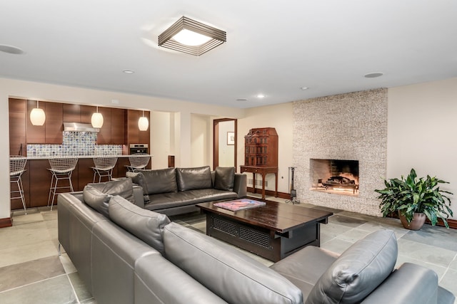 living room with a large fireplace and recessed lighting