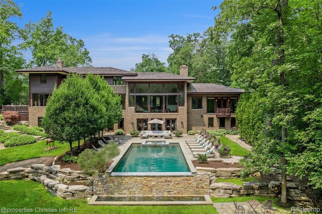 803 Canterbury Cres, Bloomfield Hills, MI 48304 - back of house featuring a balcony, a chimney, brick siding, and a patio area
