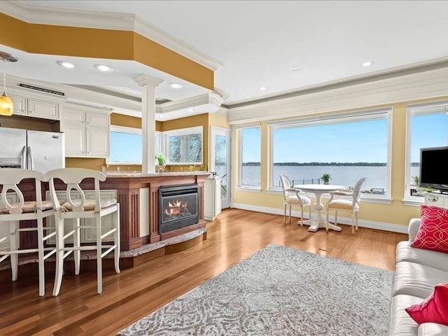 2011 W Lake Dr, Novi, MI 48377 - living area featuring crown molding, light wood-type flooring, beverage cooler, baseboards, and a glass covered fireplace