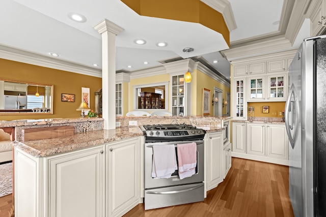 2011 W Lake Dr, Novi, MI 48377 - kitchen featuring stainless steel appliances, ornate columns, crown molding, white cabinets, and glass insert cabinets