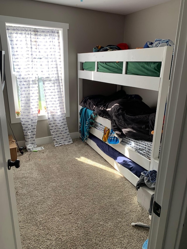 bedroom featuring carpet flooring and baseboards