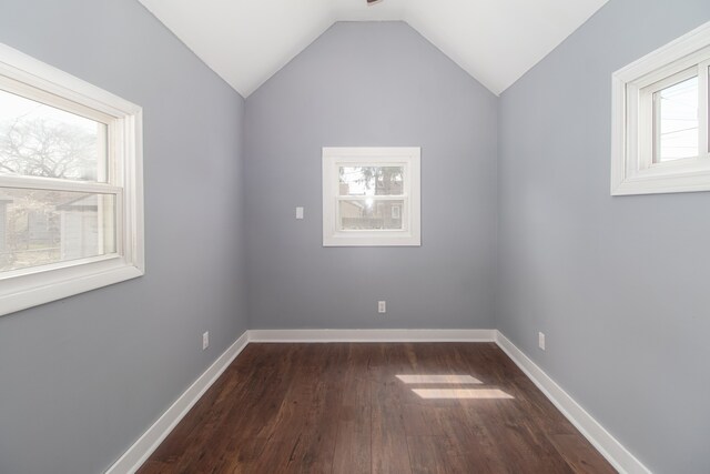 881 Garfield Ave, Lincoln Park, MI 48146 - empty room with dark wood-type flooring, baseboards, and vaulted ceiling