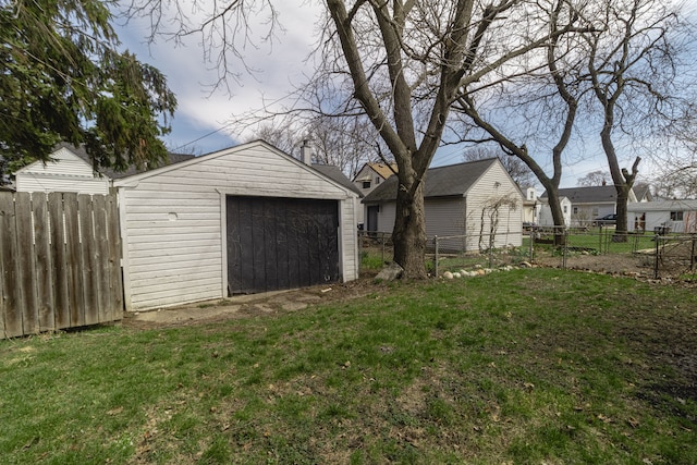 881 Garfield Ave, Lincoln Park, MI 48146 - view of front of home with a front yard, an outdoor structure, fence, and a detached garage
