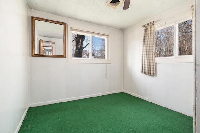 unfurnished room with baseboards, carpet flooring, and a textured ceiling