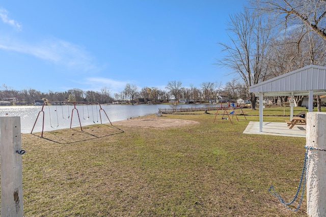 view of yard with a water view and playground community