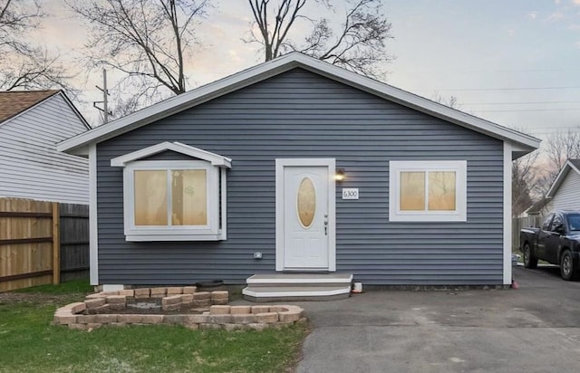bungalow with entry steps and fence