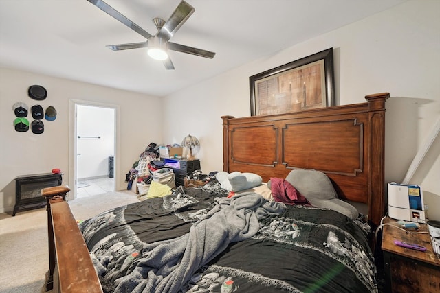 bedroom featuring ensuite bathroom, ceiling fan, and light carpet