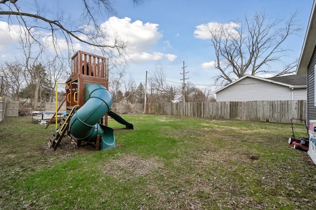 view of playground featuring fence and a lawn
