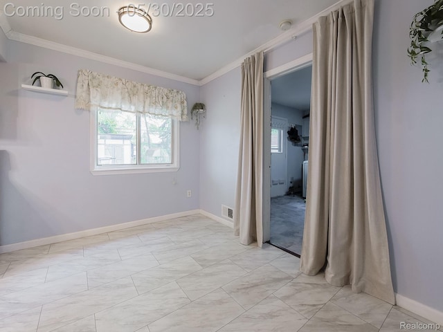 45 E George Ave, Hazel Park, MI 48030 - spare room featuring crown molding, healthy amount of natural light, light marble finish floors, and baseboards