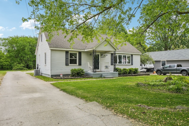 49212 Fuller Rd, Chesterfield, MI 48051 - view of front of house with a shingled roof, a front lawn, central air condition unit, and driveway
