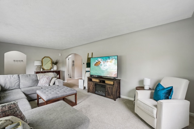 49212 Fuller Rd, Chesterfield, MI 48051 - living area featuring arched walkways, light carpet, and baseboards