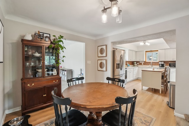 49212 Fuller Rd, Chesterfield, MI 48051 - dining room with light wood-type flooring, a chandelier, and baseboards