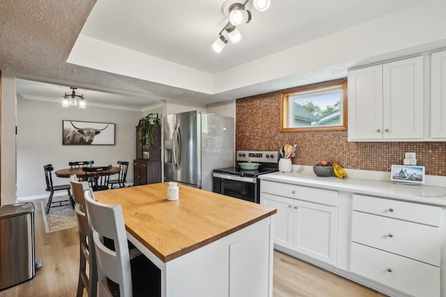 49212 Fuller Rd, Chesterfield, MI 48051 - kitchen featuring stainless steel appliances, wood counters, light wood-style flooring, and white cabinetry