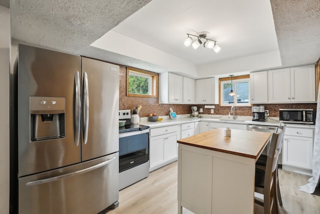 49212 Fuller Rd, Chesterfield, MI 48051 - kitchen with appliances with stainless steel finishes, butcher block countertops, a sink, tasteful backsplash, and a textured ceiling