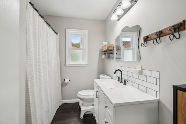 49212 Fuller Rd, Chesterfield, MI 48051 - full bathroom featuring backsplash, vanity, toilet, wood finished floors, and baseboards