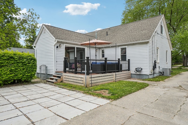 49212 Fuller Rd, Chesterfield, MI 48051 - rear view of property with central air condition unit, roof with shingles, a wooden deck, and a patio