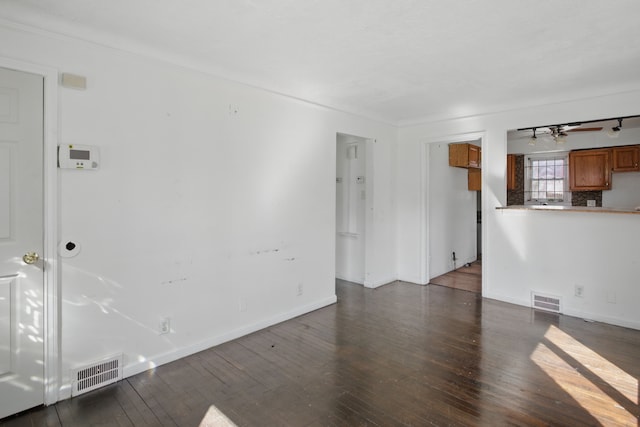 unfurnished living room with visible vents, baseboards, hardwood / wood-style floors, and a ceiling fan