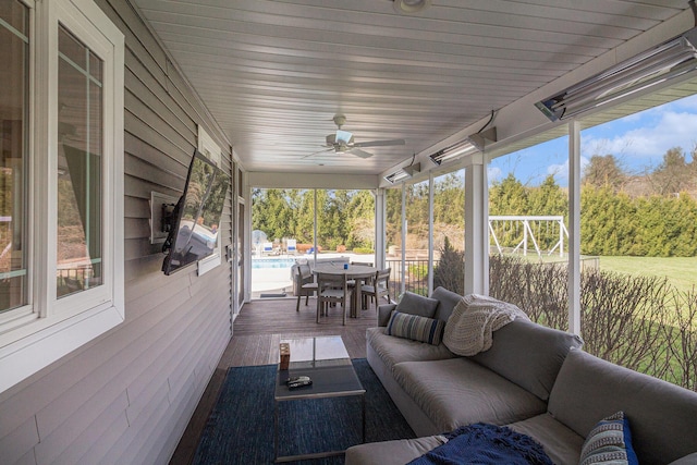 sunroom with outdoor lounge area, ceiling fan, and a healthy amount of sunlight