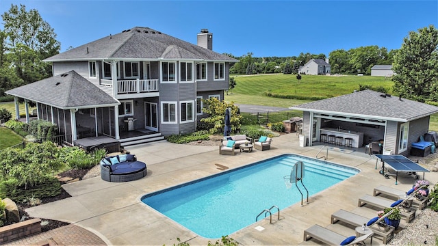pool featuring an outdoor structure, grilling area, an outdoor living space with a fire pit, a patio area, and a yard