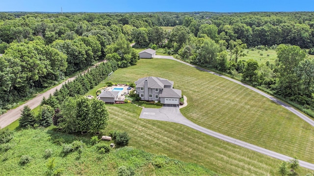 bird's eye view with a view of trees and a rural view