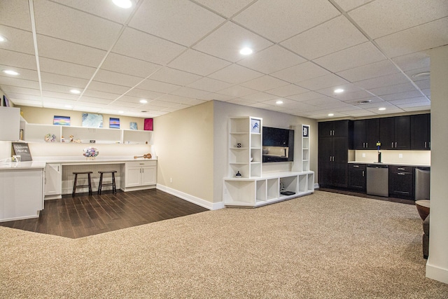 unfurnished living room with recessed lighting, indoor wet bar, baseboards, and dark carpet