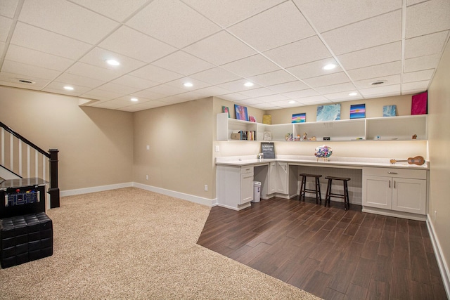 home office featuring built in study area, dark wood finished floors, baseboards, and recessed lighting