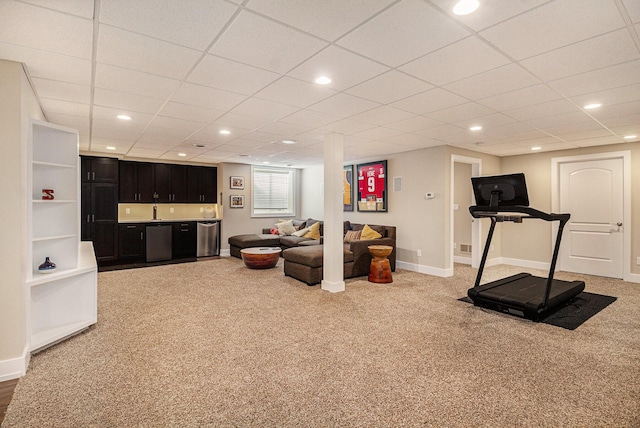 workout room featuring carpet floors, baseboards, recessed lighting, and a paneled ceiling