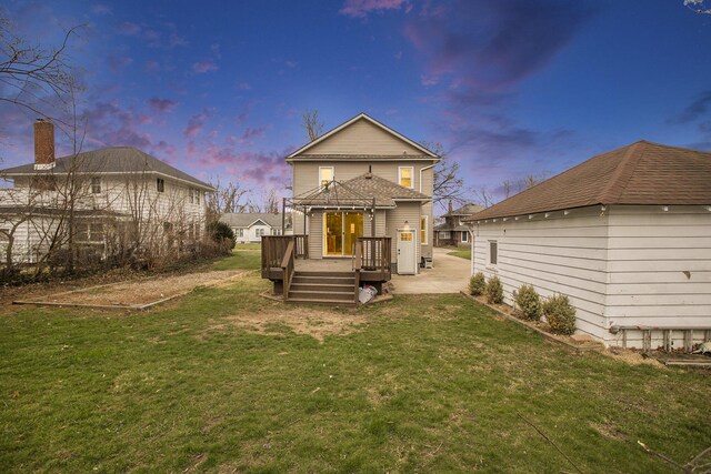 249 Wentworth Ave, Battle Creek, MI 49015 - back of property featuring a yard, a wooden deck, and a patio