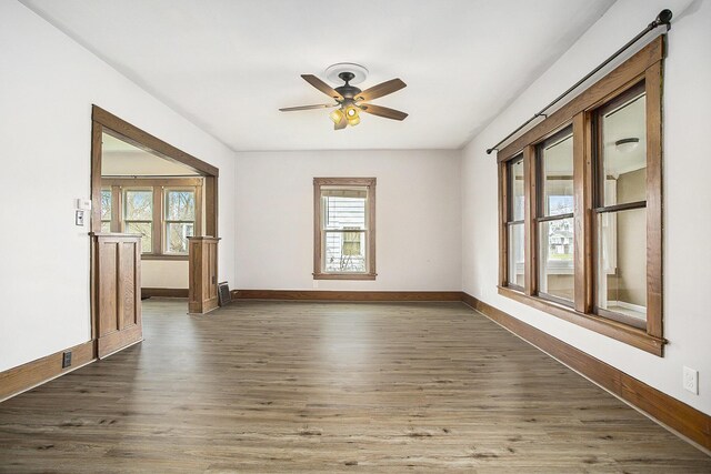 249 Wentworth Ave, Battle Creek, MI 49015 - spare room featuring dark wood-style flooring, baseboards, and a ceiling fan