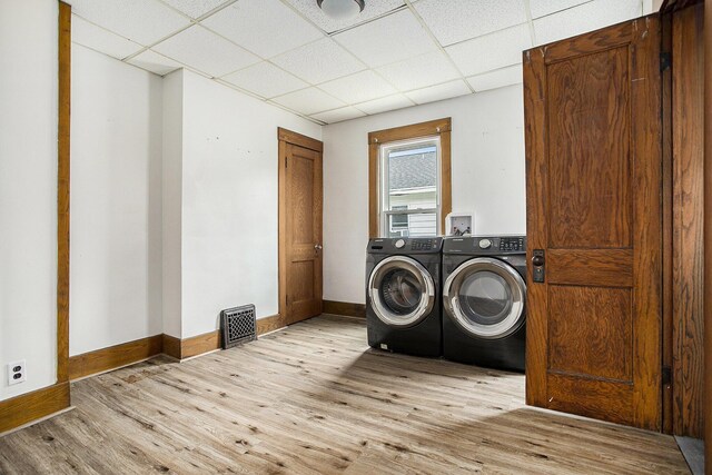 249 Wentworth Ave, Battle Creek, MI 49015 - washroom featuring baseboards, visible vents, laundry area, light wood finished floors, and washing machine and clothes dryer