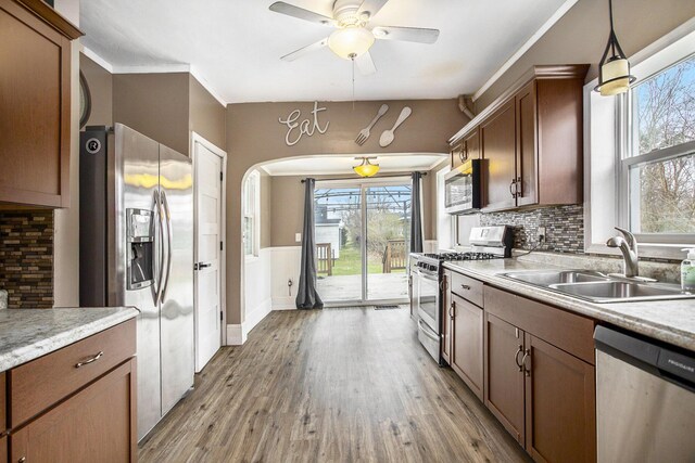 249 Wentworth Ave, Battle Creek, MI 49015 - kitchen featuring a sink, ceiling fan, appliances with stainless steel finishes, and light wood-style flooring