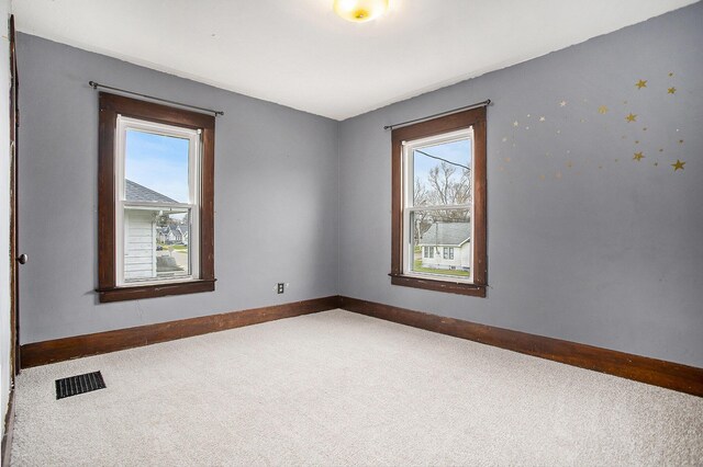 249 Wentworth Ave, Battle Creek, MI 49015 - spare room with visible vents, baseboards, plenty of natural light, and carpet