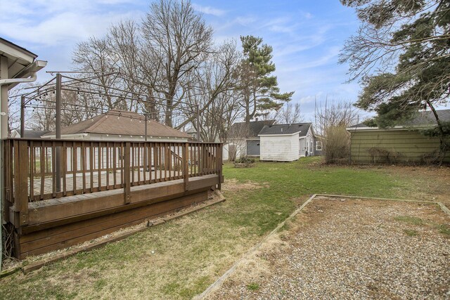 249 Wentworth Ave, Battle Creek, MI 49015 - view of yard with an outbuilding, a wooden deck, and a shed