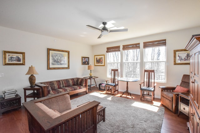 living room with dark wood-style floors and a ceiling fan