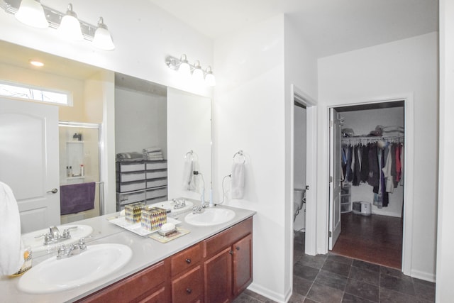 1068 Spring Trl, Brighton, MI 48116 - bathroom with double vanity, a walk in closet, and a shower stall