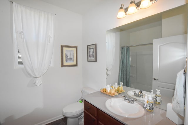 bathroom featuring toilet, a shower with curtain, and vanity