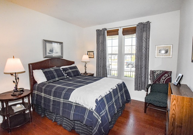 bedroom with baseboards and wood finished floors