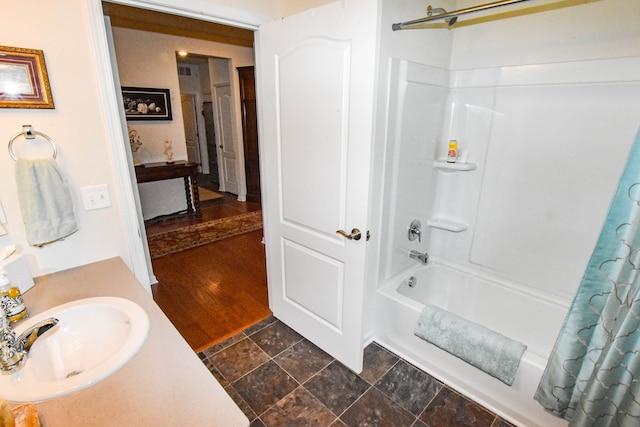 bathroom featuring vanity and shower / bath combo