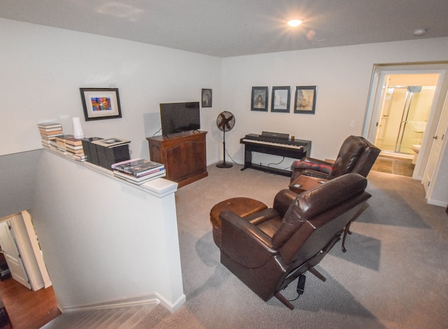 carpeted living room with baseboards