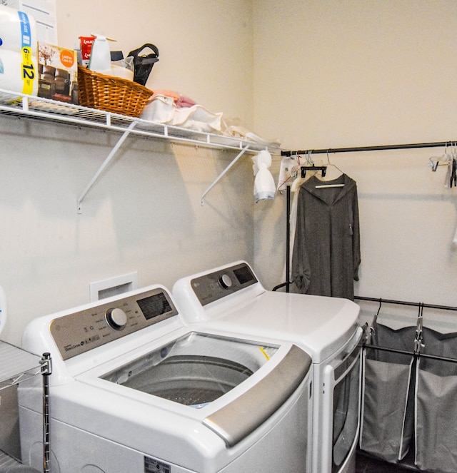 laundry area with washing machine and clothes dryer and laundry area