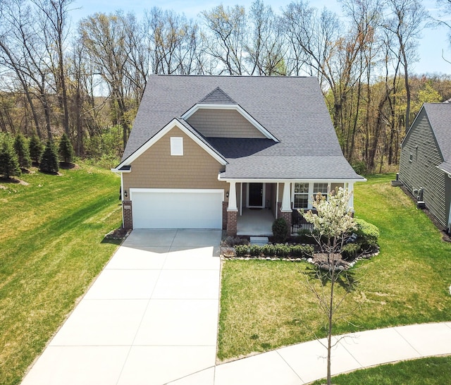 view of front of house with driveway, a porch, an attached garage, and a front yard