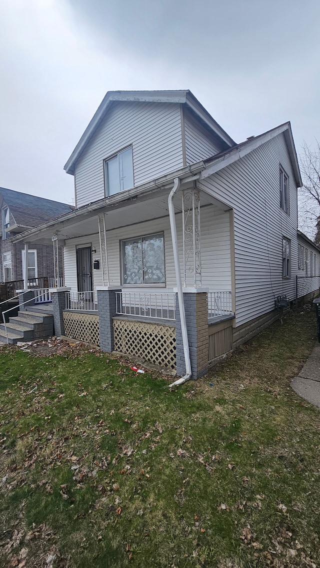 4107 N Campbell St, Detroit, MI 48210 - view of front of home with covered porch and a front yard