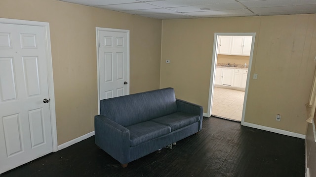 4107 N Campbell St, Detroit, MI 48210 - living area with dark wood-style floors, baseboards, and a drop ceiling